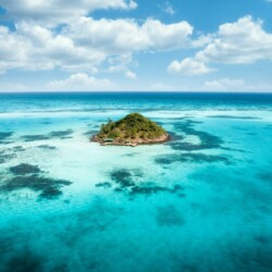 Stunning aerial view of a tropical island surrounded by vibrant turquoise waters off the coast of Colombia.